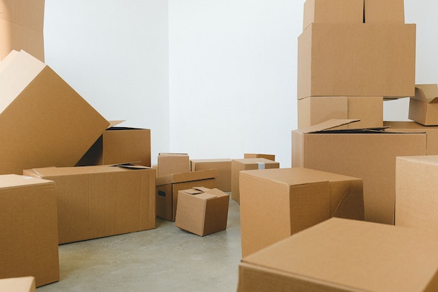 Pile of cardboard boxes scattered on floor during a move